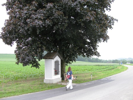 Karin zischt an einer Kapelle unter einem wunderprächtigen Blutahornbaum vorbei